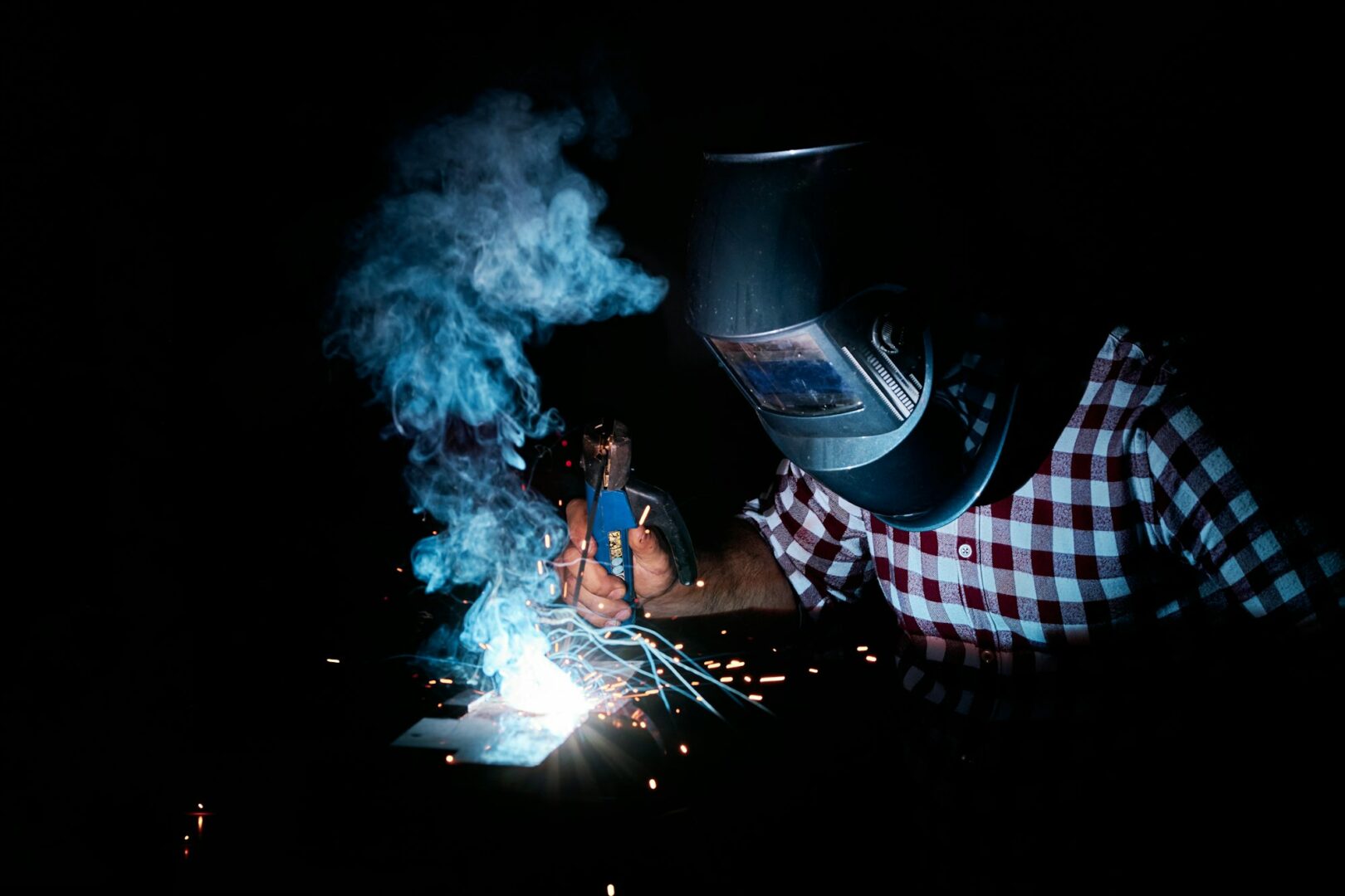 man welding in an industrial workshop