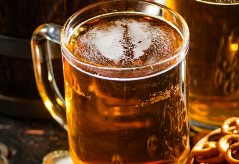 Beer in glasses with salted pretzels. On wooden background