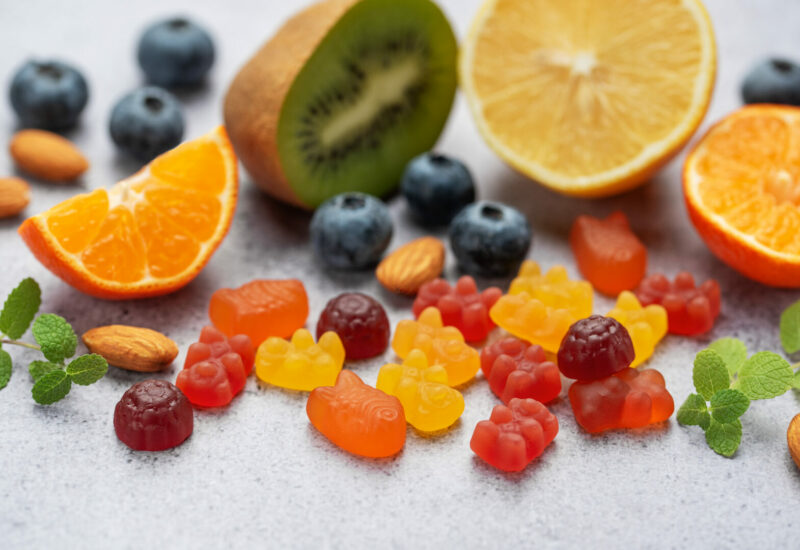 Chewable gummy bears vitamins and supplements and fresh fruits